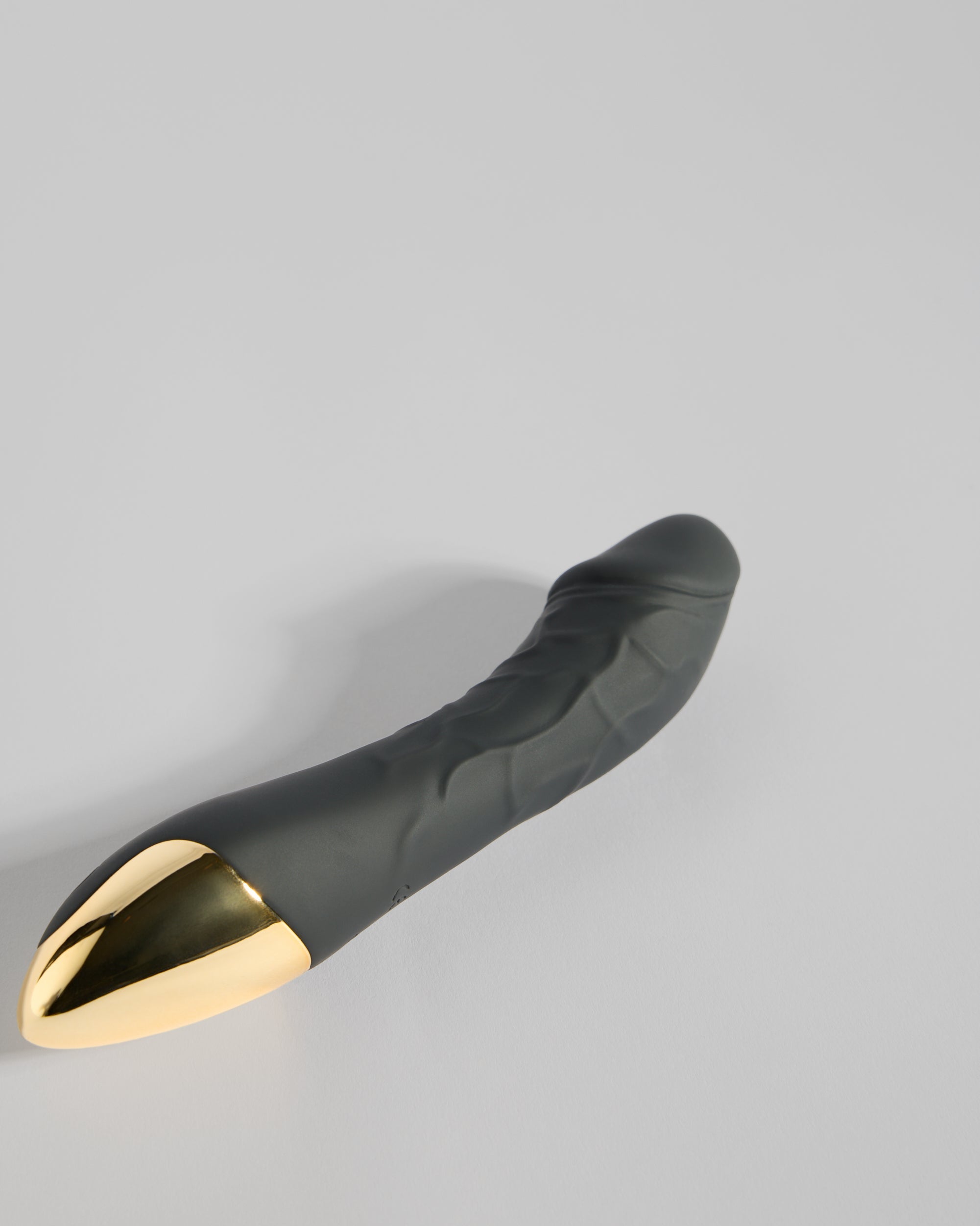 The Nikita Sweet Serenity Wellness in black with gold-toned base, displayed in a minimal studio flat lay.