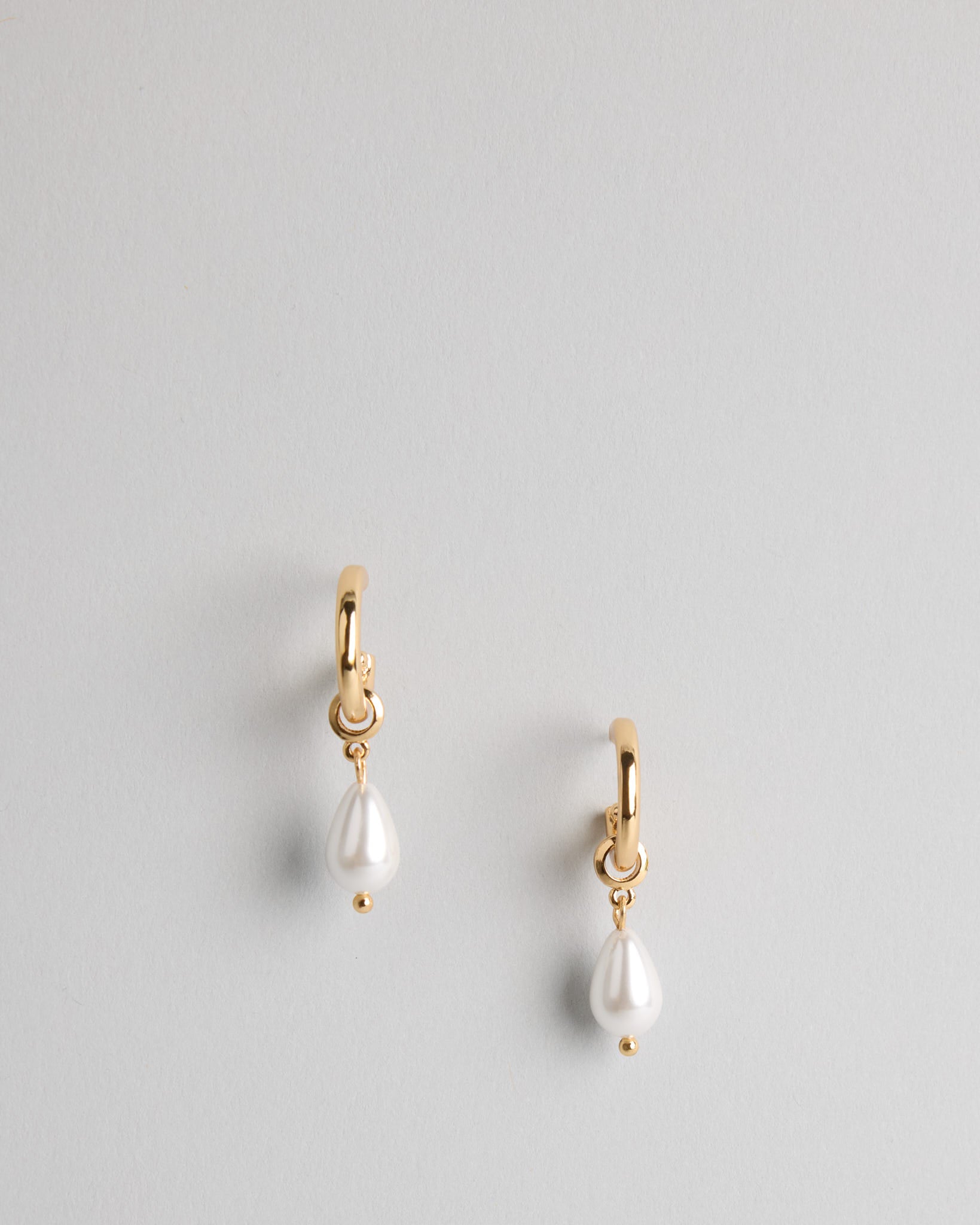 The Candace Drop Pearl Earrings – minimalist gold and pearl drop earrings photographed against a soft neutral background by SELF Seductions