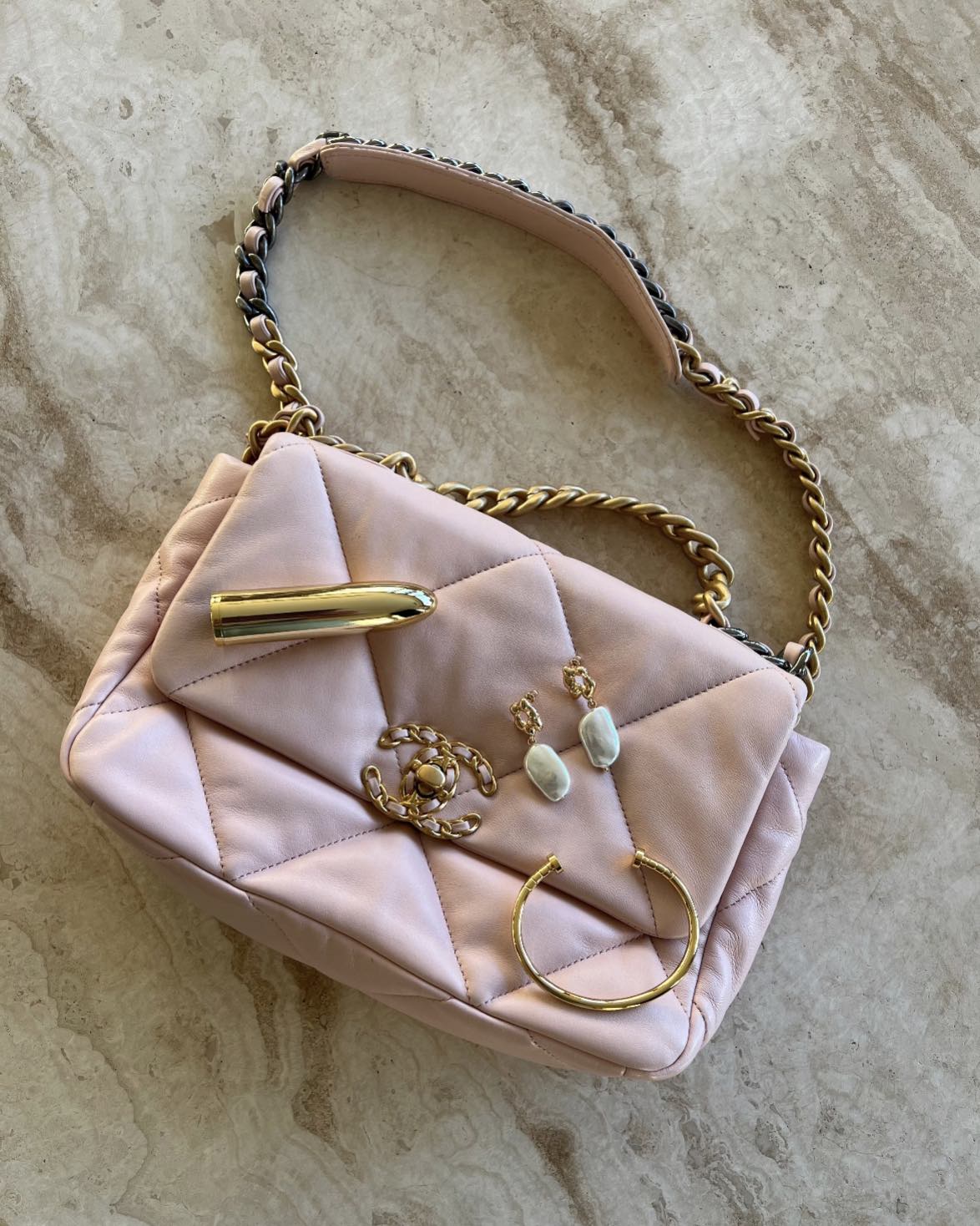 The Belle gold mini massager styled with quilted bag and jewellery – sophisticated SELF Seductions aesthetic