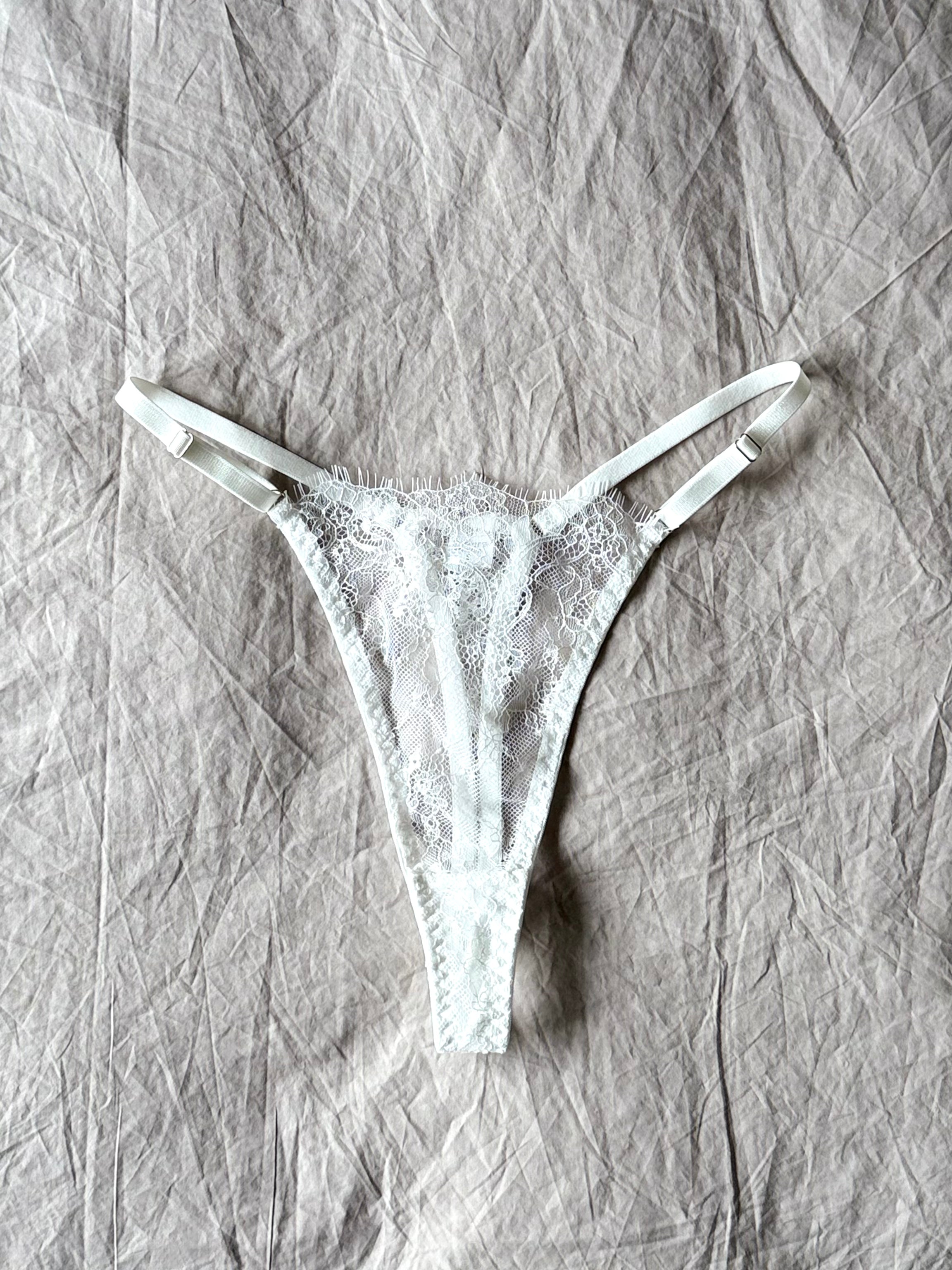 The Emma Soft Stretch Lace Thong in white – delicate lace lingerie styled on softly wrinkled linen bedding by SELF Seductions
