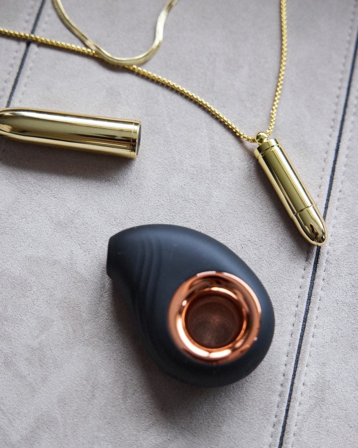 Close-up of the Leonora Air Wave Massager in black and rose-gold with jewellery – sophisticated SELF Seductions style