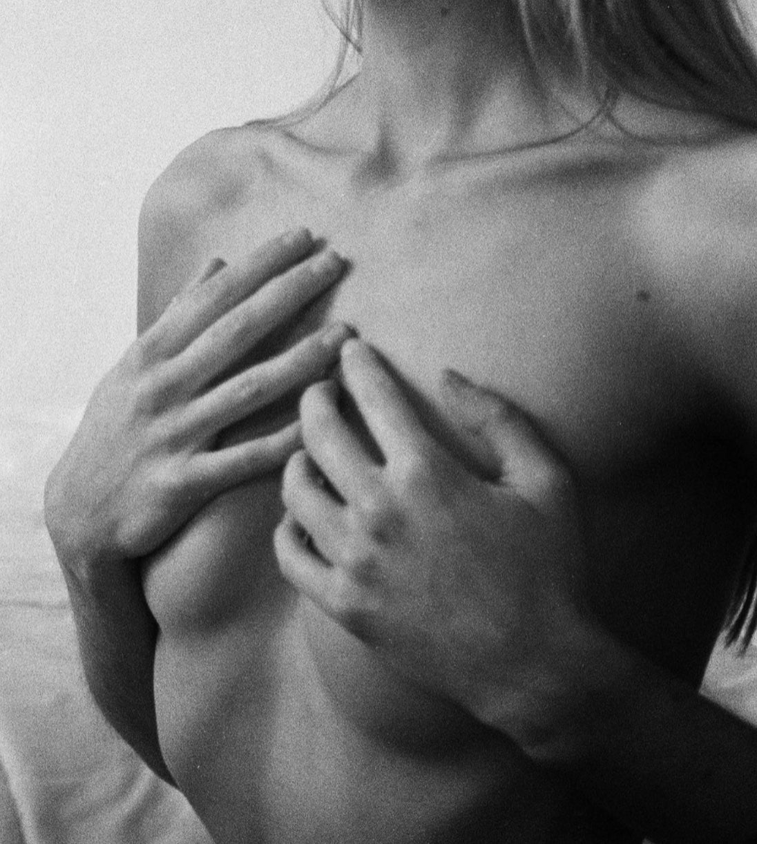 Black and white photo of a woman covering her chest with her hands, SELF Seductions intimate wellness brand.