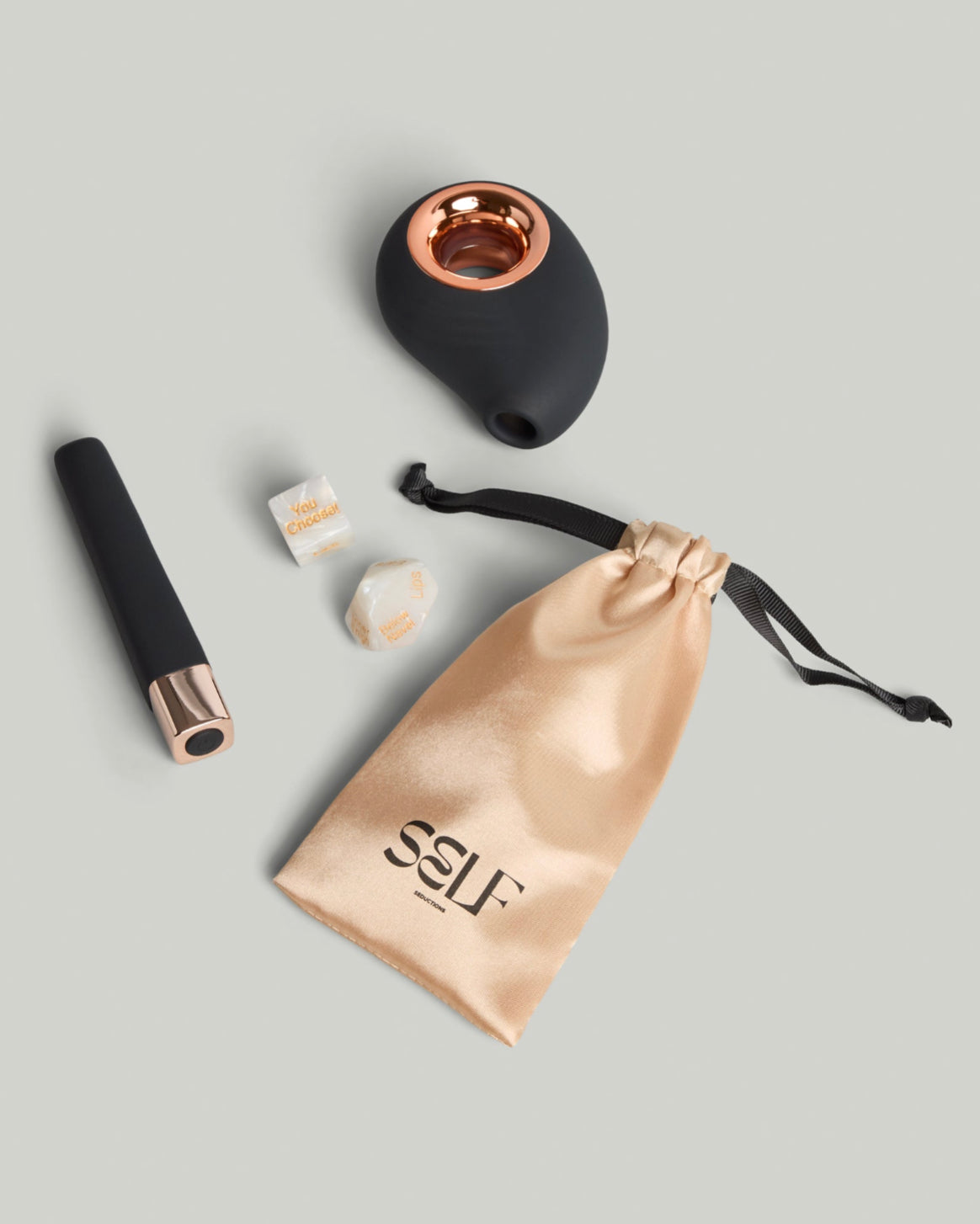 The SELF Stockholm Seduction Ritual Set with black and rose gold massagers, satin SELF pouch and intimate accessories styled on neutral studio background.