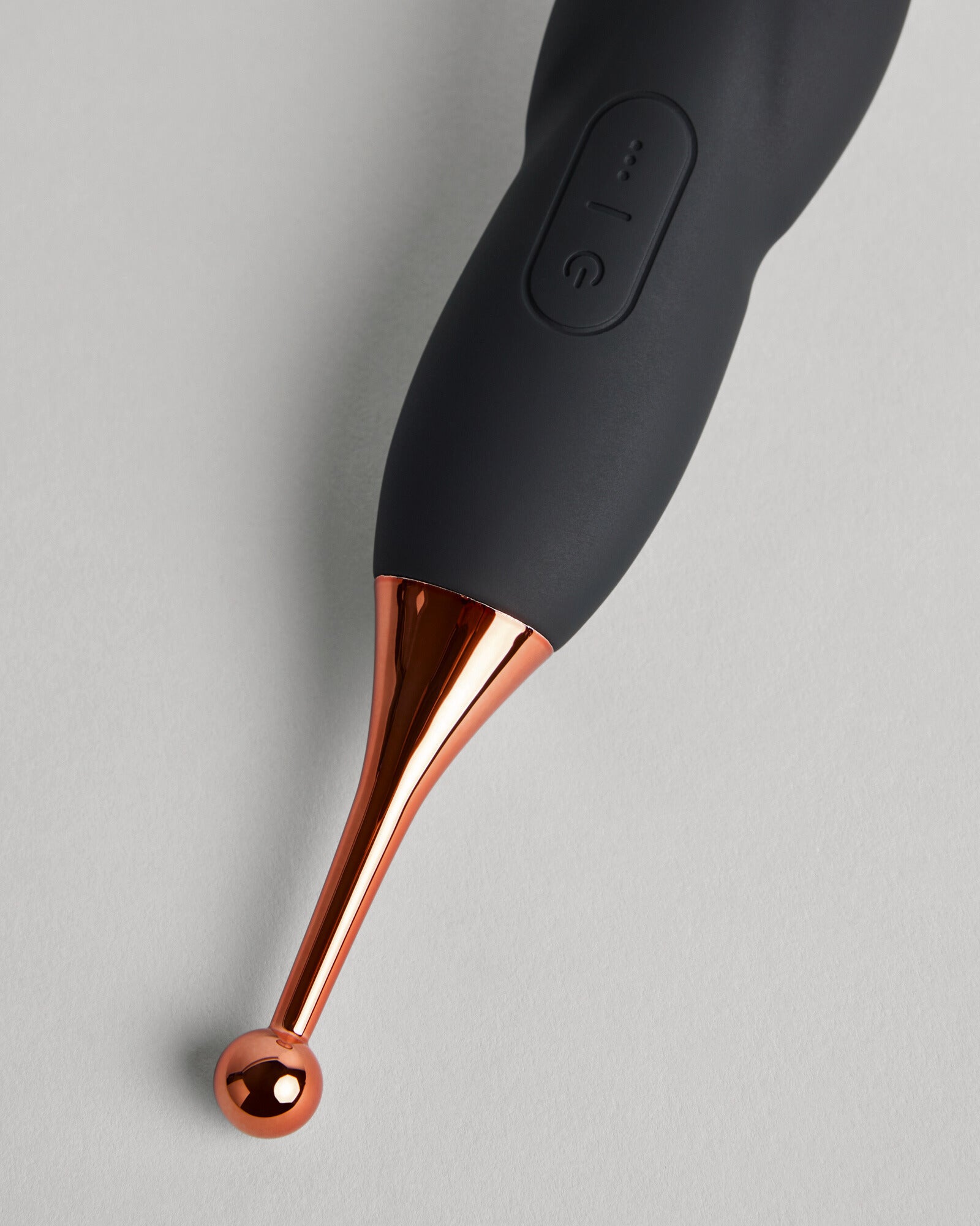 Detail view of the Serena Spellbound black touch-free wellness device with copper finish by SELF Seductions