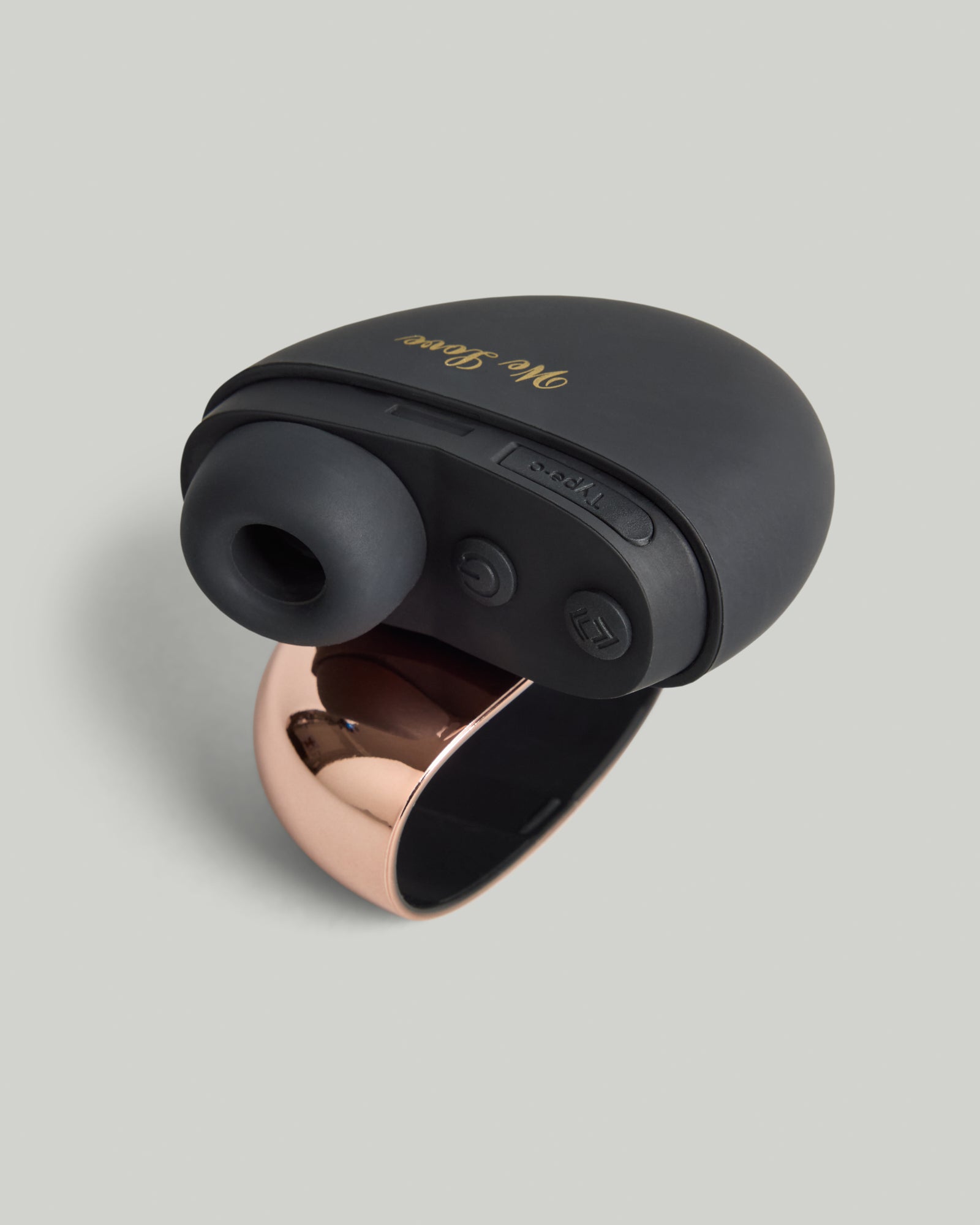 Black touch-free air wave massager with soft silicone and rose-gold edge, front studio view.