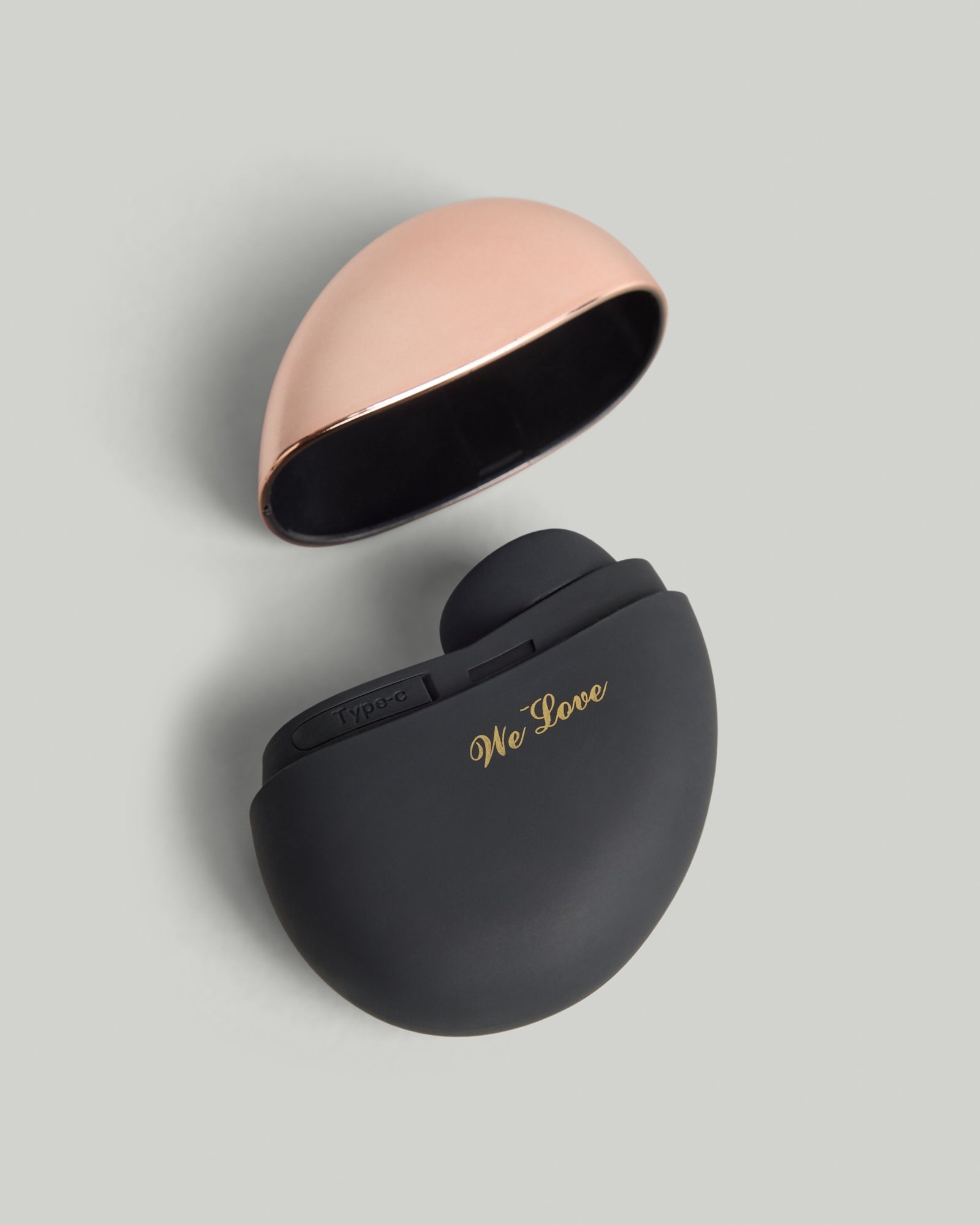 Valérie Touch-Free Air Wave Massager in matte black with rose-gold accent, studio shot on light background.